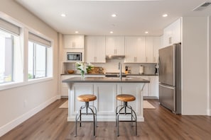 Bar seating, granite counters, full size kitchen. 