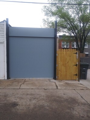 roll-up door to parking pad view from alley entrance