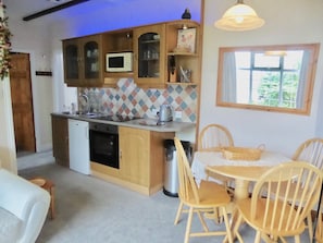 THE NEWLY FITTED GALLEY KITCHEN,
WITH PINE DINING / AREA LOOKS OUT TO THE GARDEN