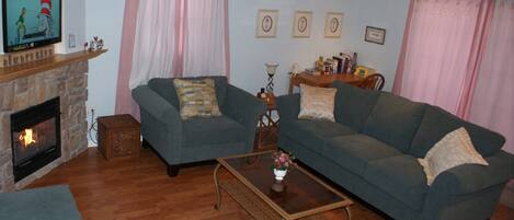 Living Room with LED TV, Fireplace, and Ceiling Fan