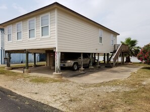 Front of House with Back with 4Runner parked underneath the house.