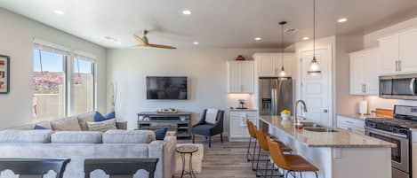 Side View of Living Area - The living room is designed as an open floor plan and is a great gathering place for meals, games, or watching TV during your stay. Notice the view from this room!