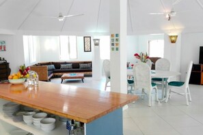 An open plan living area connected to the kitchen and breakfast bar.