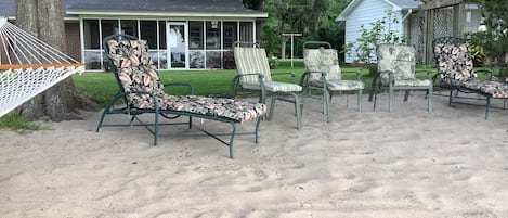 comfy chairs in sand and shade