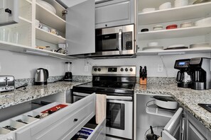 Step into this fully-equipped kitchen and discover the heart of the home. From the sleek stainless steel appliances to the ample counter space and storage, every feature has been carefully crafted for both form and function.