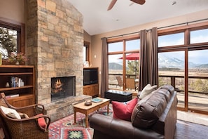 Enjoy a roaring fire as you look out at the expansive valley below.