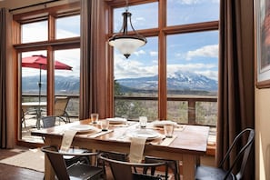 Interior dining room and exterior dining area overlooking the valley below.