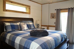 Downstairs bedroom with king bed and French doors that open into the back yard.