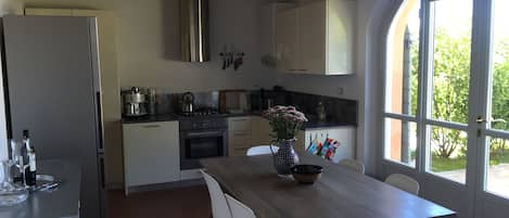 Fully stocked kitchen looking out on to private courtyard