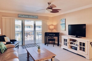 Living room with sliding glass doors that lead to your private balcony