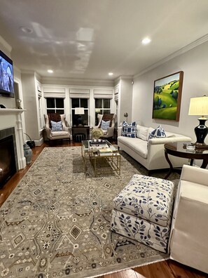 Newly refurnished living room with game table for four and honor bar cart