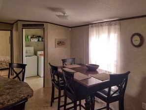 Dining area. Partial view of laundry room with full washer and dryer 