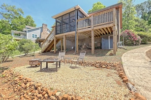 Rear view of property with screened porch and open deck. Notice the firepit and seating.