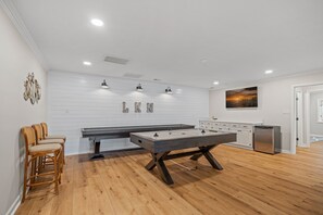 Game room with pool table & shuffle board.