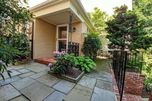 Private front door entrance to apartment and private patio on right