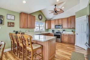Well stocked kitchen with walk-in pantry and modern appliances.