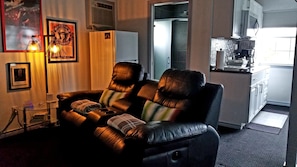 Leather motorized recliners and full fridge in background