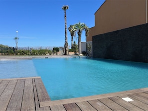 Water, Sky, Property, Plant, Daytime, Building, Swimming Pool, Street Light, Azure, Tree