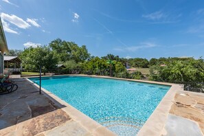 10 foot pool featuring 4 barstools and a diving board 