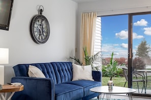 A futon sofa bed graces the room, with a captivating lake view accessible from the adjacent balcony.