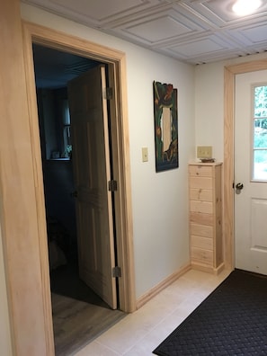 Entrance, with bedroom door on the left.