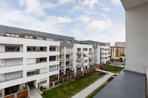 A view of the building’s exterior, showcasing balconies and a modern apartment structure.
