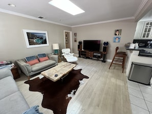 Living room with 2 couches, 50 in TV, fine art, smooth flow to kitchen area