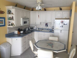 Updated kitchen w/octagonal table and swivel chairs