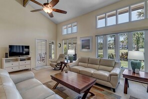 - Bask in natural light from the floor to ceiling windows and glass patio door with golf views beyond
- Comfy seating and soft neutrals invite rest and connection
- Watch a movie, read a book, or simply enjoy the beautiful outdoors from within