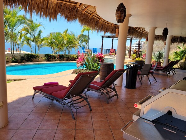 Relax on large pool deck with sun or shade options.  Grill in foreground.