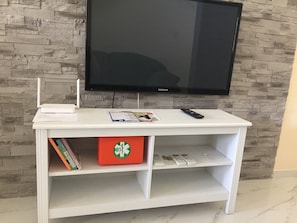 TV 43 inches, in the cabinet below:
Books and first aid kit