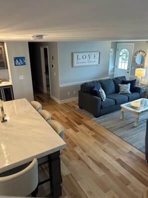 Gathering area, living room with 6-8 person island adjacent for creating fun.