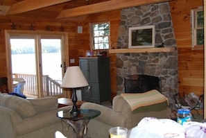 Living room with stone fireplace.  (Green cabinet has been replaced by built-in)