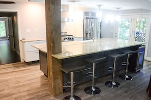 Kitchen Island from West Patio doors.  Floating shelves have been added.