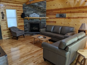 Living room with beautiful stone fireplace.  Gas fireplace with remote. 