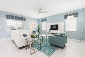 Elegant Living Area of the Home in Davenport Florida - Experience serenity in living area adorned with soft green hues - Inviting to unwind and relax in a soothing ambiance - Smart TV and Netflix - Comfy sofas