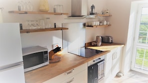 Kitchen with a door that leads straight out to the garden.