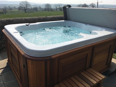 Set on a working Dairy farm  stunning views, a hot tub and pet freindly