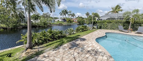 Relax by the pool overlooking the water 