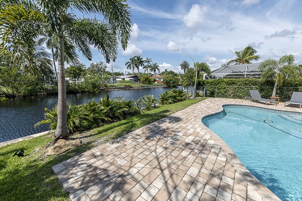 Relax by the pool overlooking the water 