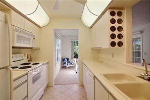 Your kitchen clean and open with a view to the dining room.