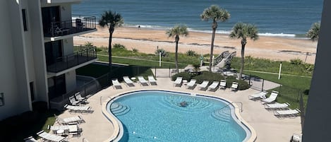 View of the pool and the beach from the balcony