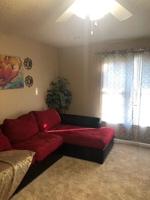 Living room with large windows to let the sunshine in.