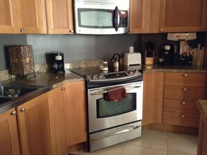 Kitchen, granite countertops, stainless appliances, ceramic tile floor