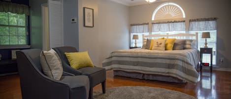 Main bedroom with a king-sized bed and sitting area