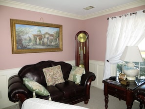 Loveseat in livingroom with original art