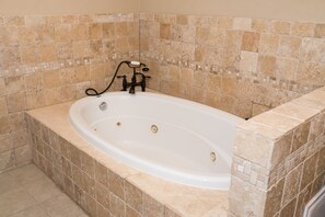 3rd floor primary bathroom with jacuzzi tub, shower and walk-in closet