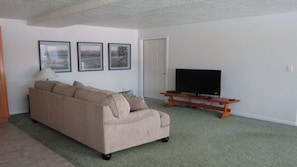 Living Space - Cozy sofa with side table & lamp, beautiful Alaskan art, tv & dvd