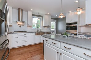 Kitchen view, rear door to patio and parking