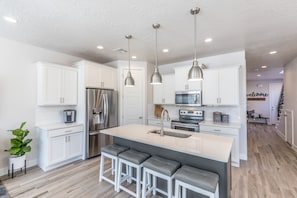 Kitchen View - The Kitchen is complete with everything you will need for meal preparations including pots, pans, baking dishes, plates, cups, silverware, cutlery, and an assortment of cooking utensils.